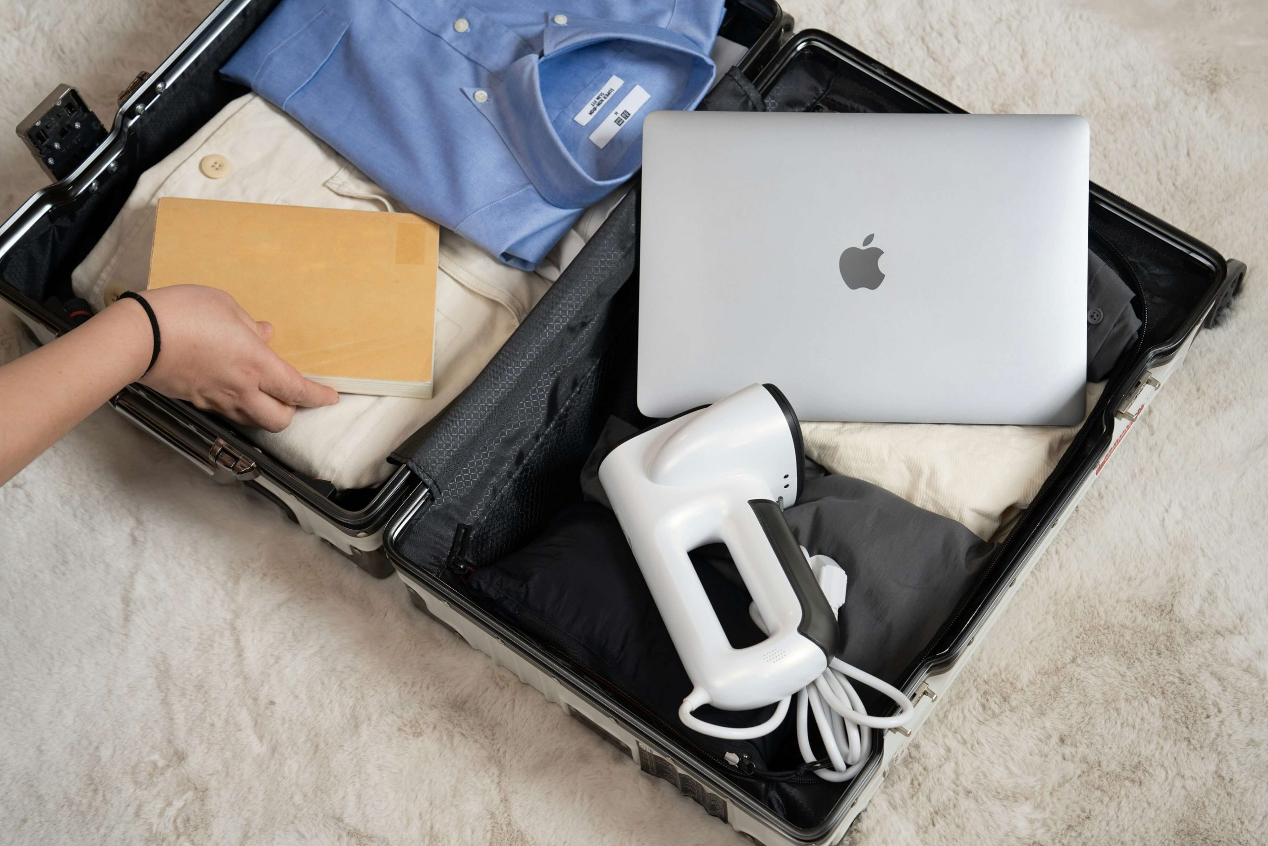 a man packing a suitcase